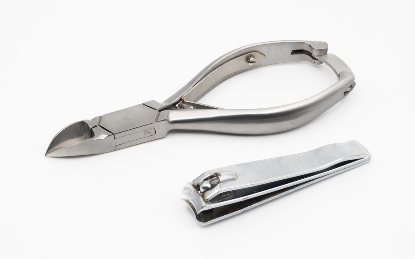 A nail clipper and a small metal nipper